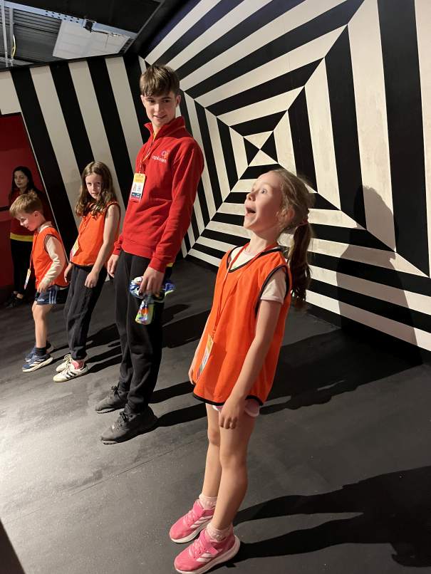 Child exploring balance and force concepts in the interactive Gravity Room