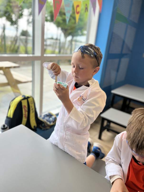 Campers creating colorful slime and conducting exciting science experiments