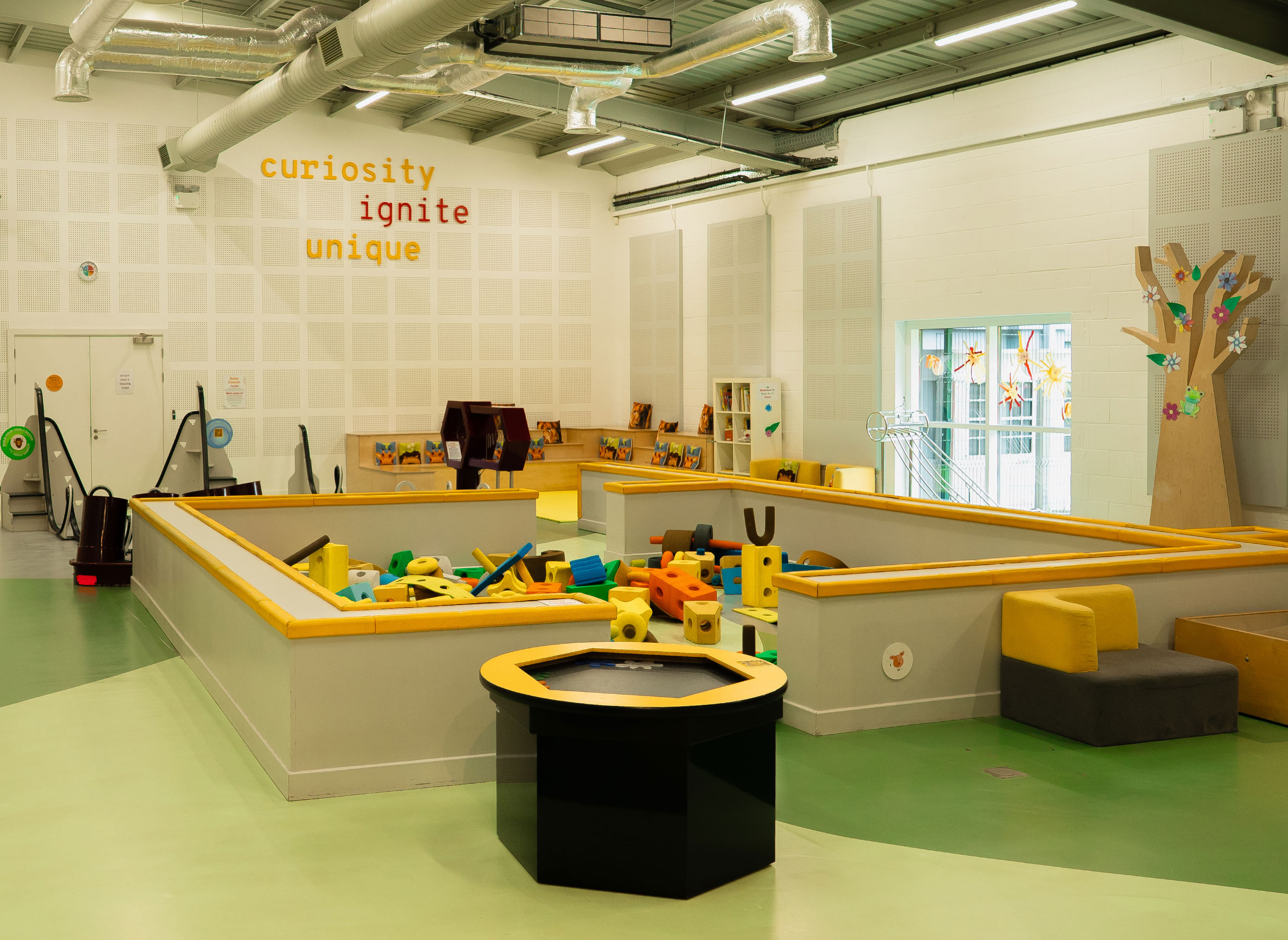 Children's play area with colorful blocks and educational decor promoting curiosity and learning.